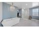 Luxurious main bathroom with a freestanding tub, walk-in shower, and elegant chandelier at 298 Watteau Ct, Henderson, NV 89012
