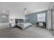 Spacious main bedroom with a king bed, work station, and ensuite bathroom with a chandelier at 298 Watteau Ct, Henderson, NV 89012