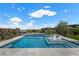 Inviting pool area with lounge chairs, serene landscaping, and a clear blue sky at 298 Watteau Ct, Henderson, NV 89012