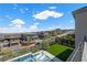 Inviting pool and lounge area with an artificial turf backyard space and city views at 298 Watteau Ct, Henderson, NV 89012