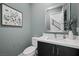 Powder room features modern vanity with framed mirror and tasteful decor at 298 Watteau Ct, Henderson, NV 89012