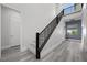 Elegant staircase with modern railing and natural light filtering through a nearby window at 298 Watteau Ct, Henderson, NV 89012