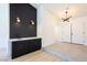 Stylish entryway featuring a modern bar area with dark cabinets and chic lighting fixtures at 3156 Shadowridge Ave, Las Vegas, NV 89120