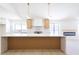 Bright kitchen featuring a stylish island with quartz countertop and decorative wood paneling at 3156 Shadowridge Ave, Las Vegas, NV 89120