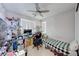 Functional room with a bed, desk, ceiling fan and many windows providing great natural light at 3360 Lochside Dr, Henderson, NV 89044