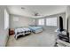 This is a bright bedroom featuring two beds, carpet floors, a ceiling fan and multiple windows at 3360 Lochside Dr, Henderson, NV 89044