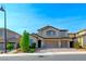 Inviting two-story home featuring a three-car garage and an attractive desert landscape at 3360 Lochside Dr, Henderson, NV 89044