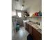 Functional laundry room features tile floors, granite counters, sink, washer and dryer hookups and storage at 3360 Lochside Dr, Henderson, NV 89044