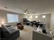 Spacious living area with neutral carpet, ceiling fan, and plentiful windows offering natural light at 3360 Lochside Dr, Henderson, NV 89044