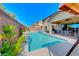 Sparkling in-ground pool surrounded by lush landscaping and comfortable seating at 3360 Lochside Dr, Henderson, NV 89044