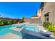 Stunning swimming pool and hot tub with a mosaic tile wall, surrounded by desert landscaping at 3360 Lochside Dr, Henderson, NV 89044