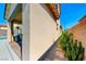 View of a the side of the house with a stone pathway and minimal landscaping at 3360 Lochside Dr, Henderson, NV 89044