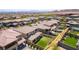 Residential aerial view showcasing expansive community, nearby desert landscaping, complemented by lush green backyards at 395 Prairie Sun St, Las Vegas, NV 89138
