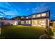 Serene backyard with a covered patio and lush artificial grass offering a low-maintenance and inviting outdoor space at 395 Prairie Sun St, Las Vegas, NV 89138