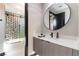 Modern bathroom with unique tile design, a sleek vanity, and a stylish round mirror at 395 Prairie Sun St, Las Vegas, NV 89138