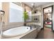 Elegant bathroom with a modern soaking tub, glass shower, and stylish finishes for a spa-like experience at 395 Prairie Sun St, Las Vegas, NV 89138