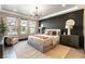 Inviting bedroom with contemporary lighting, a plush bed, accent wall and view to the garden at 395 Prairie Sun St, Las Vegas, NV 89138