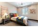 Charming bedroom featuring stylish decor, a comfortable bed, and a decorative light fixture at 395 Prairie Sun St, Las Vegas, NV 89138
