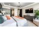 Bedroom featuring contemporary lighting, a comfortable bed, TV, and a relaxing seating area at 395 Prairie Sun St, Las Vegas, NV 89138