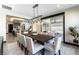 Bright dining room featuring a large table, stylish chandelier, and sliding glass doors for seamless outdoor access at 395 Prairie Sun St, Las Vegas, NV 89138