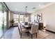 Bright dining room featuring a large table, stylish chandelier, and sliding glass doors for seamless outdoor access at 395 Prairie Sun St, Las Vegas, NV 89138