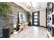 Modern entryway boasting stylish tile accents, contemporary lighting, artistic wall decor, and lush potted plants at 395 Prairie Sun St, Las Vegas, NV 89138