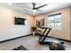 Well-lit exercise room featuring a treadmill, weights, and a view of the outdoors at 395 Prairie Sun St, Las Vegas, NV 89138