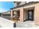 Inviting front porch with stylish egg chairs, brick pillars, and a modern front door with glass inserts at 395 Prairie Sun St, Las Vegas, NV 89138