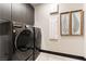 Laundry room equipped with modern washer and dryer, ample storage, and stylish decor at 395 Prairie Sun St, Las Vegas, NV 89138