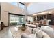 Open-concept living room with high ceilings, contemporary furnishings, and seamless access to the modern kitchen at 395 Prairie Sun St, Las Vegas, NV 89138