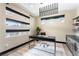 Modern home office with sleek desk, shelving, and multiple windows for natural light at 395 Prairie Sun St, Las Vegas, NV 89138