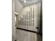 Modern wine cellar showcasing stylish racks against a tiled wall and a geometric patterned rug at 395 Prairie Sun St, Las Vegas, NV 89138