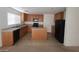 Bright kitchen with wooden cabinets, stainless steel appliances, and ample counter space at 520 Shire Hall St, Las Vegas, NV 89178