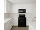 Well-lit kitchen with white cabinets, countertops, and black oven, offering a modern design at 520 Shire Hall St, Las Vegas, NV 89178