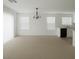 Spacious living room featuring plush carpeting, abundant natural light, and a charming chandelier at 520 Shire Hall St, Las Vegas, NV 89178