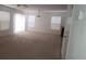 Bright living room with plush carpeting, abundant natural light, and open space at 520 Shire Hall St, Las Vegas, NV 89178