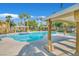 Resort-style pool with ample lounge space, mature landscaping, and covered seating areas at 950 Seven Hills Dr # 116, Henderson, NV 89052