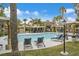 Community pool with relaxing lounge chairs, lush grass, palm trees, and covered seating at 950 Seven Hills Dr # 116, Henderson, NV 89052
