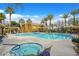 Community pool with lounge chairs, spas, covered seating, and lush landscaping at 950 Seven Hills Dr # 116, Henderson, NV 89052