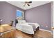 Cozy bedroom featuring modern ceiling fan, wood flooring, and large window at 10001 Peace Way # 2277, Las Vegas, NV 89147