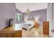 Comfortable bedroom with wood floors, lavender walls, and stylish furnishings at 10001 Peace Way # 2277, Las Vegas, NV 89147