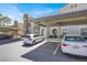 Apartment building exterior with covered parking, showing carports and well-maintained landscaping at 10001 Peace Way # 2277, Las Vegas, NV 89147