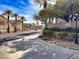 Gated entrance to Chateau Nouveau community, showcasing well-maintained landscaping and palm trees along the driveway at 10001 Peace Way # 2277, Las Vegas, NV 89147