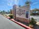 Chateau Nouveau community sign with stone accents and lush landscaping on a bright, sunny day at 10001 Peace Way # 2277, Las Vegas, NV 89147