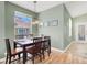Bright dining room features hardwood floors, new light fixture, and an abundance of natural light at 10001 Peace Way # 2277, Las Vegas, NV 89147