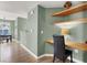 Hallway featuring laminate floors and built-in shelving, flowing into a combined living and dining space at 10001 Peace Way # 2277, Las Vegas, NV 89147