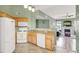 Well-appointed kitchen with white appliances, tiled floors, and an open layout to living space at 10001 Peace Way # 2277, Las Vegas, NV 89147