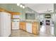 Well-appointed kitchen with white appliances, tiled floors, and an open layout to living space at 10001 Peace Way # 2277, Las Vegas, NV 89147
