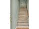 Carpeted staircase featuring a wood handrail, offering access to the upper levels of the home at 10001 Peace Way # 2277, Las Vegas, NV 89147
