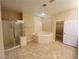 Bright bathroom featuring walk-in shower, soaking tub, and spacious closet at 10013 Scenic Walk Ave, Las Vegas, NV 89149